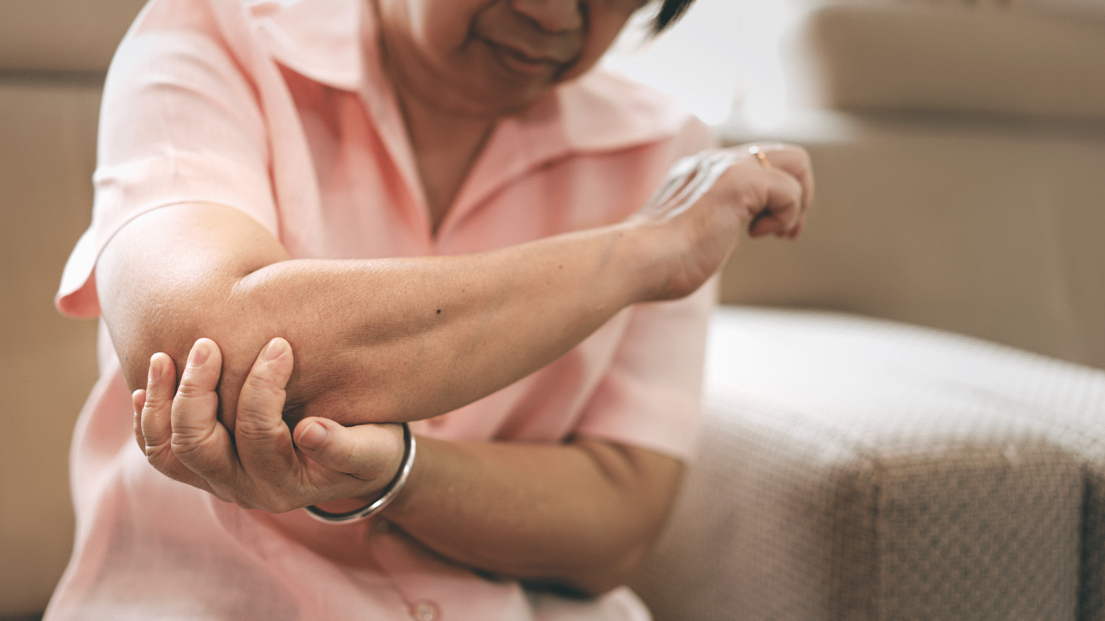 woman with elbow and shoulder pain at night